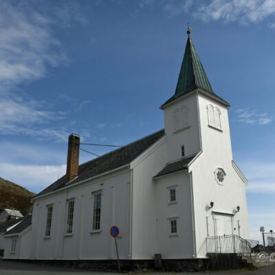 Deze witte, houten neogotische constructie vervangt de kerk van Kjelvik die in 1882 door een storm werd verwoest. Deze kerk bezat een klok die aan Sint Nicolaas gewijd was en in 1521 in Duitsland werd gegoten. Vandaag bevindt ze zich in het Noordkaapmuseum. De kerk is het enige gebouw in de stad dat gespaard bleef toen de terugtrekkende Duitse troepen in 1944 tijdens de operatie Nordlicht alles platbrandden. De hele bevolking werd, onder dwang, naar het zuiden geëvacueerd. Pas in 1969 was de wederopbouw van de stad voltooid.